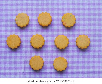 Round Butter Cookies Arranged On A Purple Table Cloth