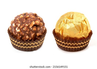 A round candy in a gold package and an unwrapped candy poured with chocolate and waffle crumbs. - Powered by Shutterstock