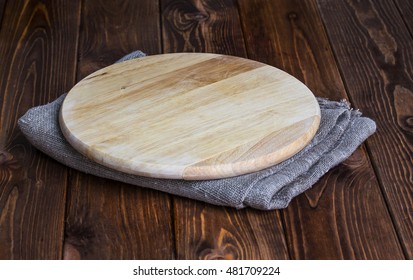 Round Chopping Board On A Wooden Table