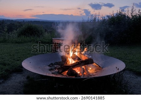 round circle fire pit burning logs at sunset in catskills mountains catskill upstate new york travel camping leisure scenic nature landscape flame wood wooden log warmth cozy outdoor adventure