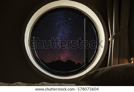 Round circle window frame with night sky full of stars with milky way