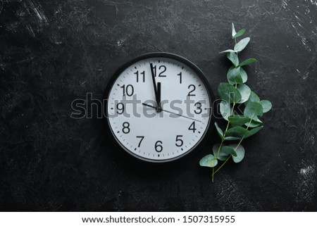Round clock with numbers on old background.