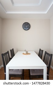 round clock on the dining table in the kitchen