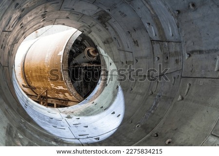 Round concrete elements or segment of a built subway tunnel under construction. Tunnel boring machine on construction site building metro. 