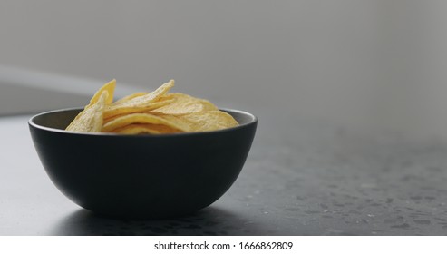 Round Corn Chips In Black Bowl Closeup