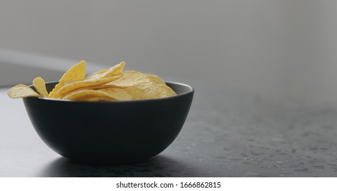 Round Corn Chips In Black Bowl Closeup