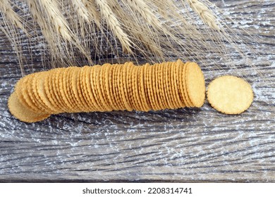 round cracker biscuits with barley plant on wood table - Shutterstock ID 2208314741