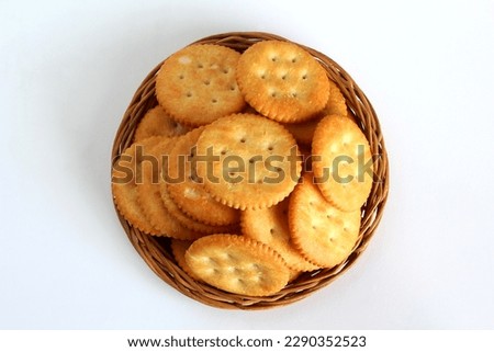 round cracker biscuits or cookie isolated in basket,top view in white background