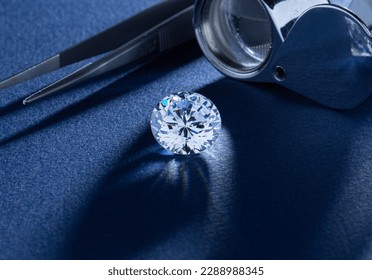 Round cut diamond on blue background.