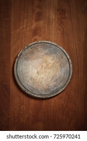 Round Cutting Board On Old Wooden Texture Background