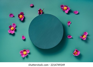 A Round Dark Teal On Blue Green Background With Purple Flowers. Scene To Show Cosmetic Podructs. Showcase, Display Case. Trendy Color 2023