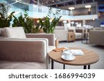 Round desk with business literature, cup of hot drink and wallet at airport waiting room stock photo