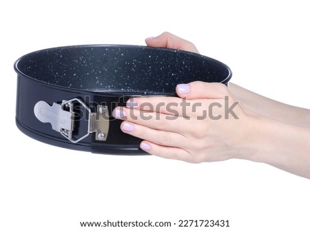 Round detachable baking dish in hand on white background isolation