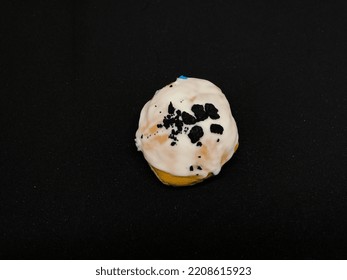 Round Donut Cake With White Vanilla Jam And Sprinkling Of Oreo Chocolate On A Black Background