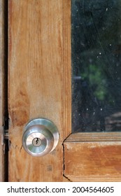 Round Doorknob On A Wooden Door, Vertical Image