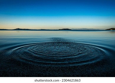 Round droplets of water over circles on the pool water. Water drop, whirl and splash. Ripples on sea texture pattern background. Desktop  laptop wallpaper. Closeup water rings affect the surface. - Powered by Shutterstock