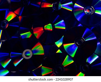 round DVDs with bright multi-colored rainbow highlights on the surface close-up