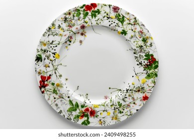 Round flat plate decorated with painted flowers isolated on white background - Powered by Shutterstock