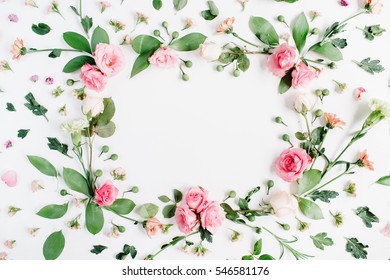 Round frame made of pink and beige roses, green leaves, branches, floral pattern on white background. Flat lay, top view. Valentine's background
