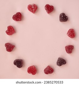 Round frame of red marmalade hearts in sugar on pink background. Place for text, greeting card. - Powered by Shutterstock