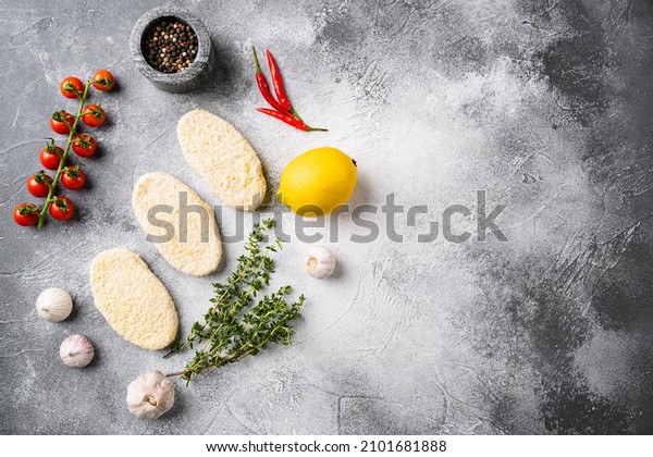 Round fresh fish cakes set,\
on gray stone table background, top view flat lay, with copy space\
for text