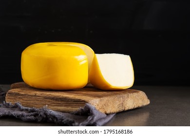 Round Gouda Cheese. Dark Background