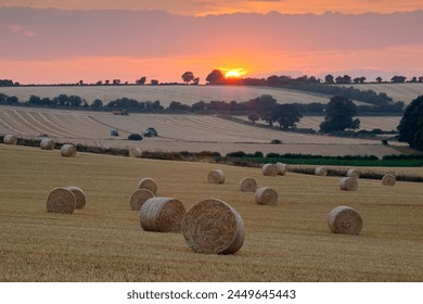 Round hay bales at harvest with sunset, Swinbrook, Cotswolds, Oxfordshire, England, United Kingdom, Europe - Powered by Shutterstock