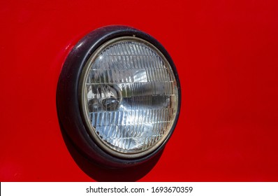 Round Headlight Of Old Red Tram Closeup