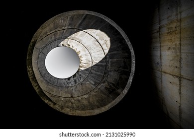 A Round Hole In The Ceiling Of An Abandoned, Concrete Building