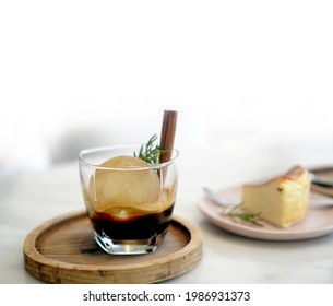 Round Ice Cube In Black Coffee Espresso Serve With Cinnamon Stick In Cafe Copy Space