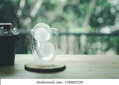 Round Ice In Double Wall Glass On Wood Table