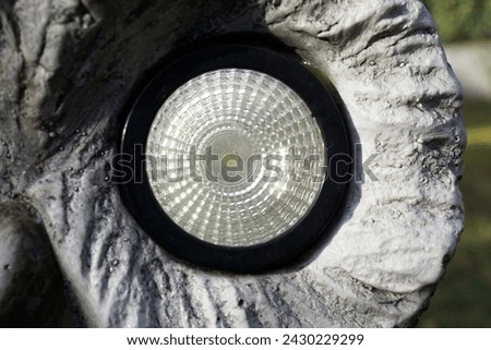 Round LED light eye embadded in stone figure                  