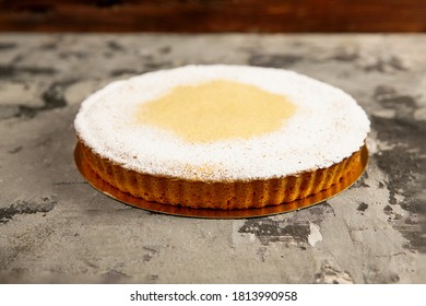  Round Lemon Cake With Powdered Sugar Lies On A Dark Textured Background