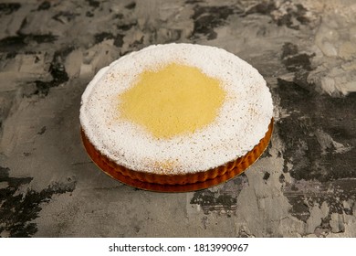  Round Lemon Cake With Powdered Sugar Lies On A Dark Textured Background