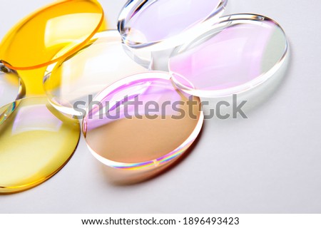 Round lenses for glasses with anti-reflective coating on a white background. Production of glasses and spectacle lenses.