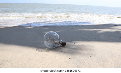 A round light bulb on the sandy beach
