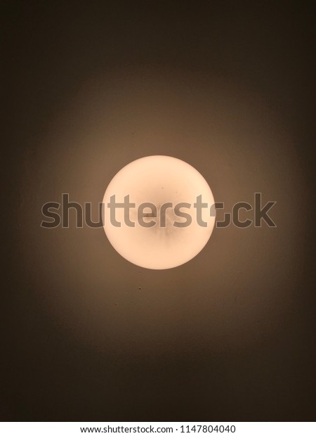 Round light globe on a\
ceiling