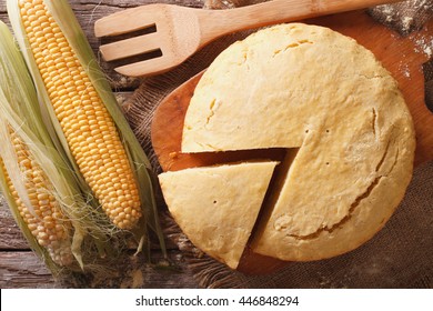 Round Loaf Of Corn Bread Close-up On A Wooden Board. Horizontal View From Above
