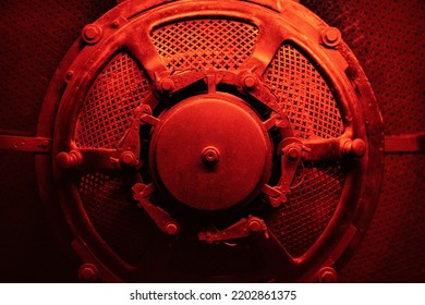 Round Machine Or Bunker Door With Red And Dramatic Lighting.