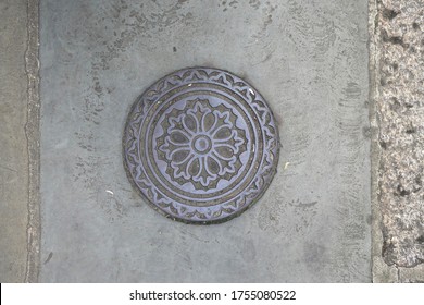 a round manhole cover decorated with circles and a floral pattern 2