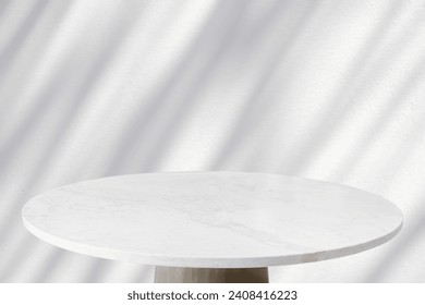 Round marble table top with tree leaves shadow drop on white wall background for mockup product display