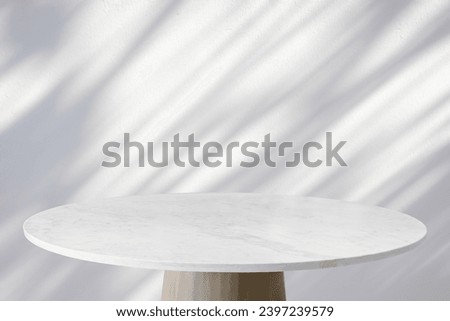 Round marble table top with tree leaves shadow drop on white wall background for mockup product display