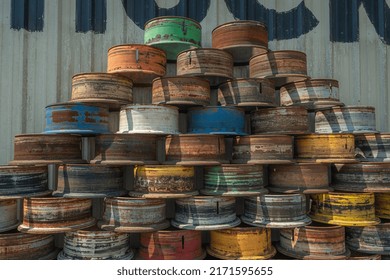 Round Metal Drums Stacked In Front Of A Truckstop. 