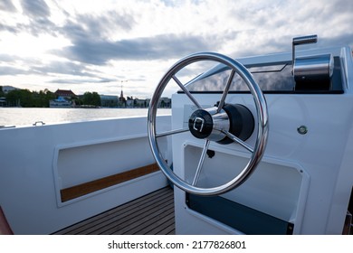 Round Metal Steering Wheel Of A Small Electric Rental Boat. Sunny Summer Day, No People.