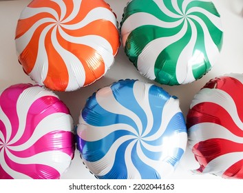 Round Multi-colored Foil Balloons Of Caramel On A White Background