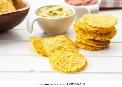 Round Nacho Chips. Yellow Tortilla Chips On White Table.