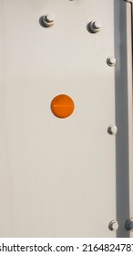 Round Orange Reflector On White Metallic Surface