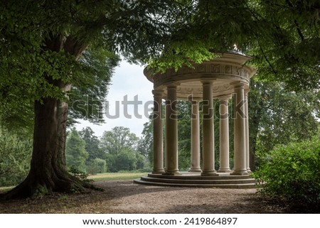 Round Pavilion with Coloums between Trees in Park, Europe