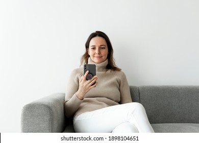 Round Phone Grip Behind The Mobile With Woman Using The Phone