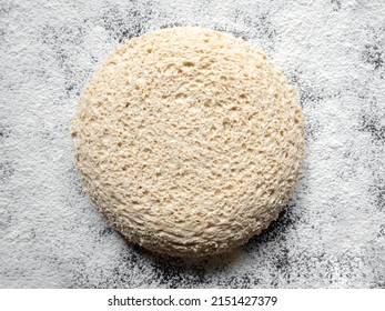 Round Piece Of Yeast-free Dough On A Floured Table. Cellular Texture Of Yeast-free Dough. White Bread Texture. Mankind Oldest Staple Foods.